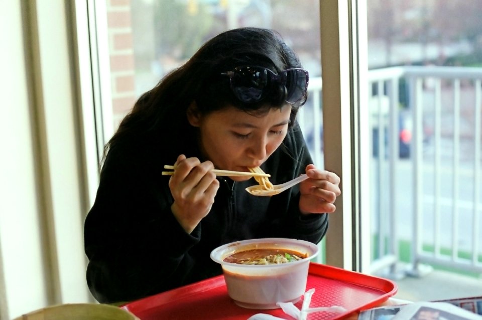 Eating Noodle Soup at Food Court