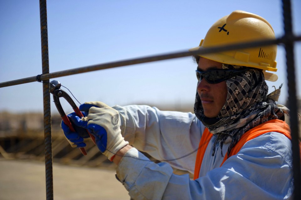 Construction worker places rebar
