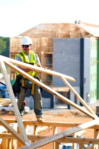 Lifting a wooden roof at WTU project site photo