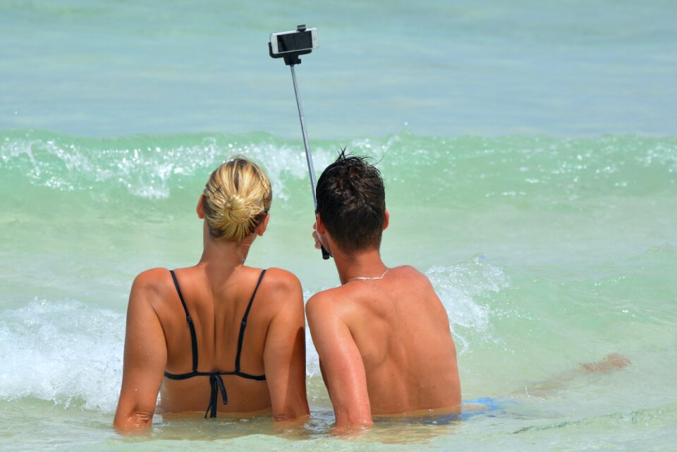 Woman selfiestick ocean