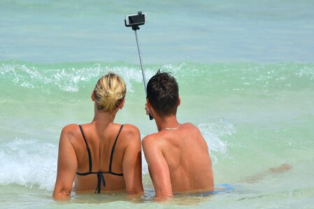 Woman selfiestick ocean