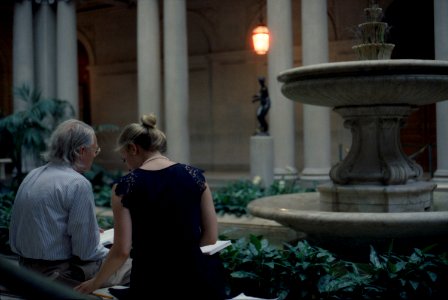 Man sitting beside Woman at Fountain photo