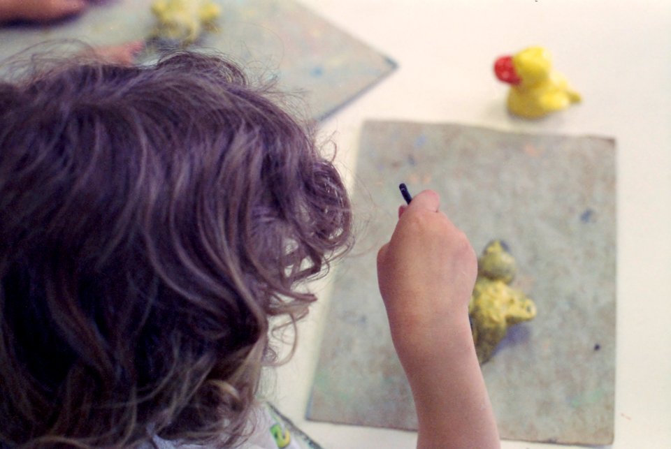 Kid drawing in art class