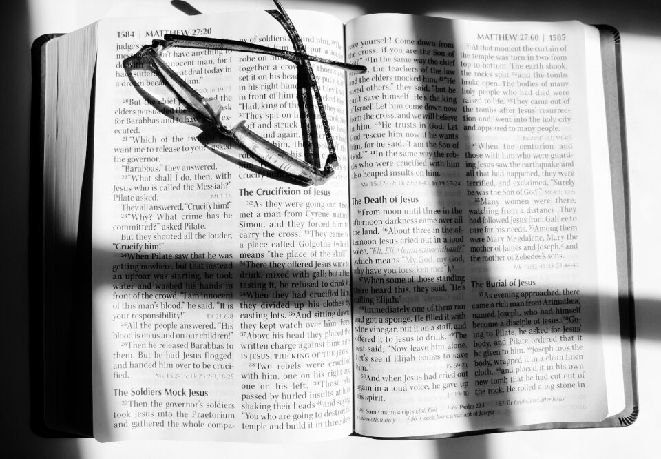 Hands reading glasses cross