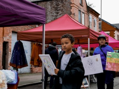 Kids selling paintings in Liverpool Granby Street market