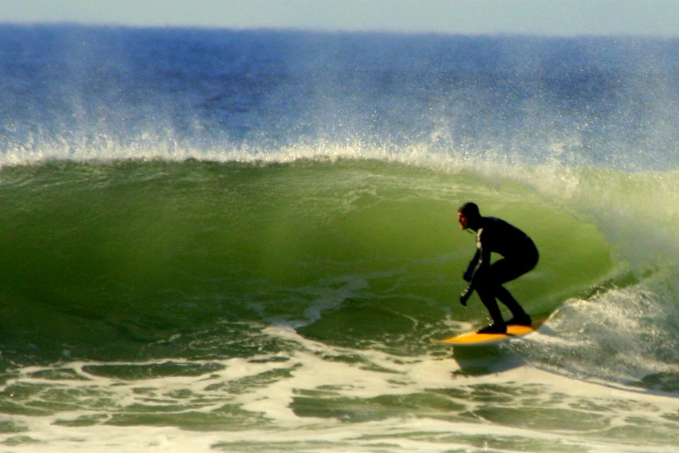 OCNMS - surfer rides green wave