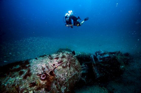 MNMS diver over shipwreck photo