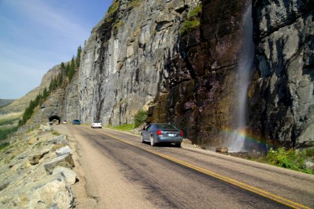 Waterfall coming onto the road photo