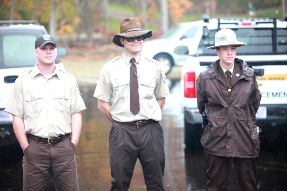 Refuge staff stand in the rain at Visitor Center Opening Event