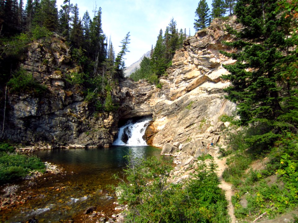Running Eagle Falls - [Two Medicine Area] - 3 (Early in the season when there is more water flowing, it cascades from both over the top of the cliff and also from the middle of the rock face visible in this photo.)