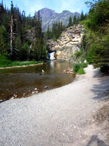 Running Eagle Falls - [Two Medicine Area] - 2 (Early in the season when there is more water flowing, it cascades from both over the top of the cliff and also from the middle of the rock face visible in this photo.)