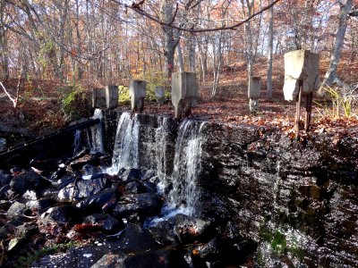 Shady Lea Mill Dam - water streams over the top of the old dam