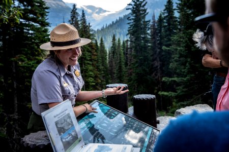 A Park Ranger talks to visitors during the "Goodbye to the Glaciers" program at Jackson Glacier Overlook. photo
