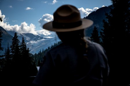 A Park Ranger talks to visitors during the "Goodbye to the Glaciers" program at Jackson Glacier Overlook. photo