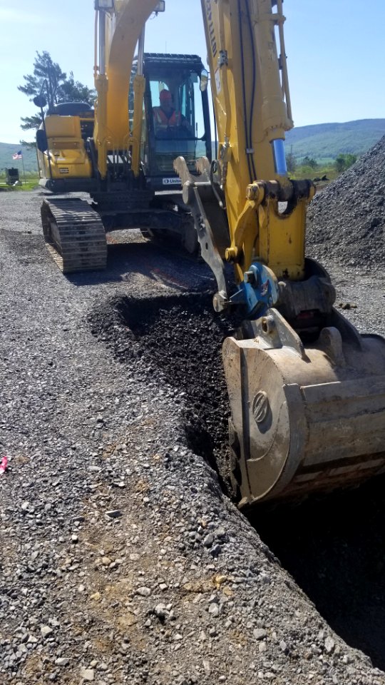 Operator removing gravel