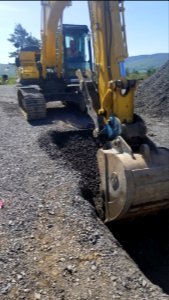 Operator removing gravel