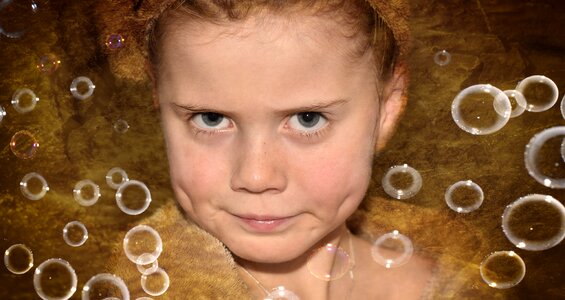 Girl face soap bubbles photo