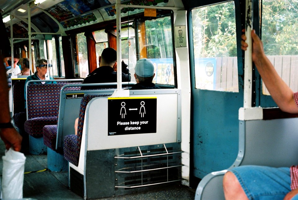 Island line 1938 stock train interior with Covid-19 social distancing notice.