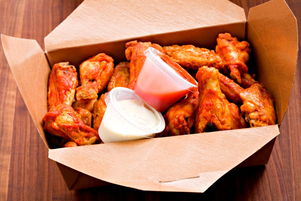 A box of chicken wings and sauces