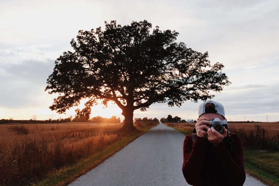 Taking picture holding camera outdoors