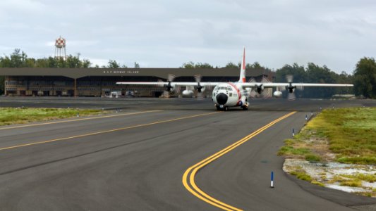 A U.S. Coast Guard C-130 taxis from the NAF Hangar to the runway