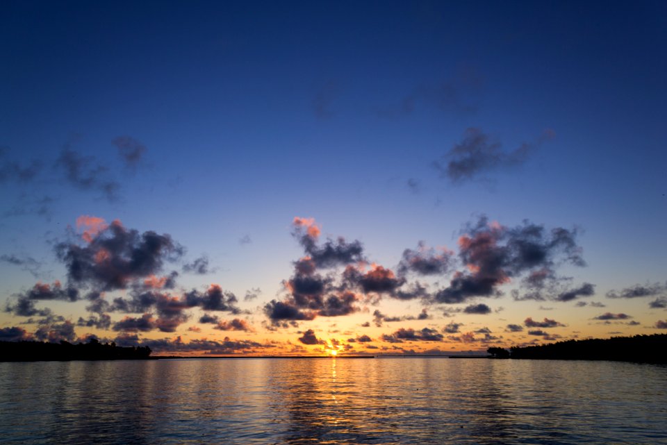 The sun rises over Midway's harbor