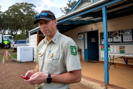 US Field Representative Alex Robertson checking messages at the Swifts Creek Base Camp