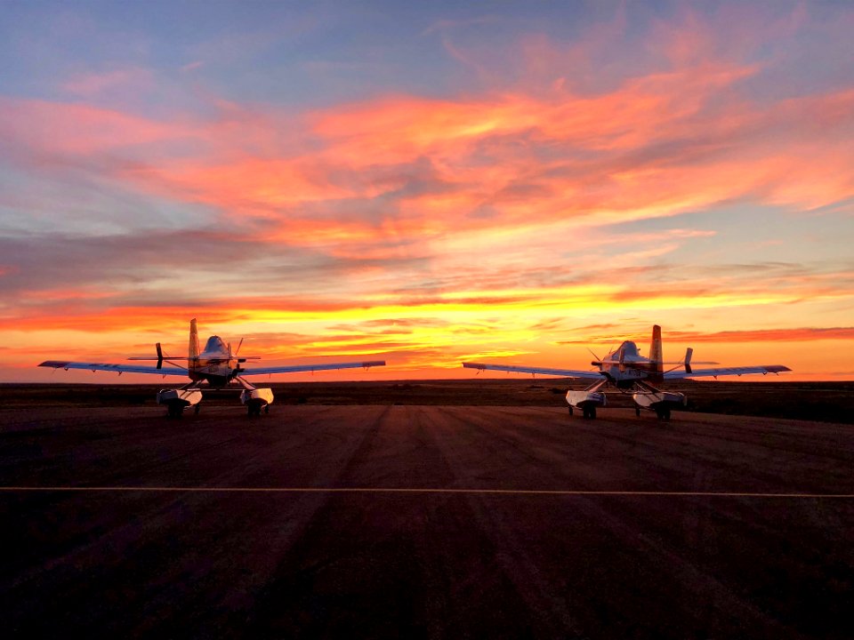 Two Fire Boss Water Scoopers parked at sunset. Photo courtesy of Ted Thompson, Mountain Home Aviation.