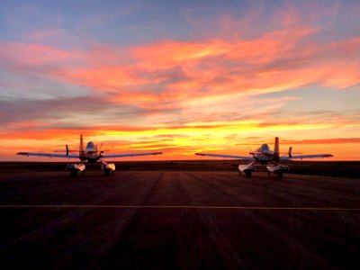 Two Fire Boss Water Scoopers parked at sunset. Photo courtesy of Ted Thompson, Mountain Home Aviation.