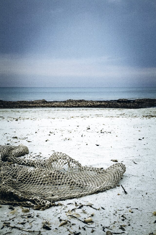 Fishing net flotsam sand