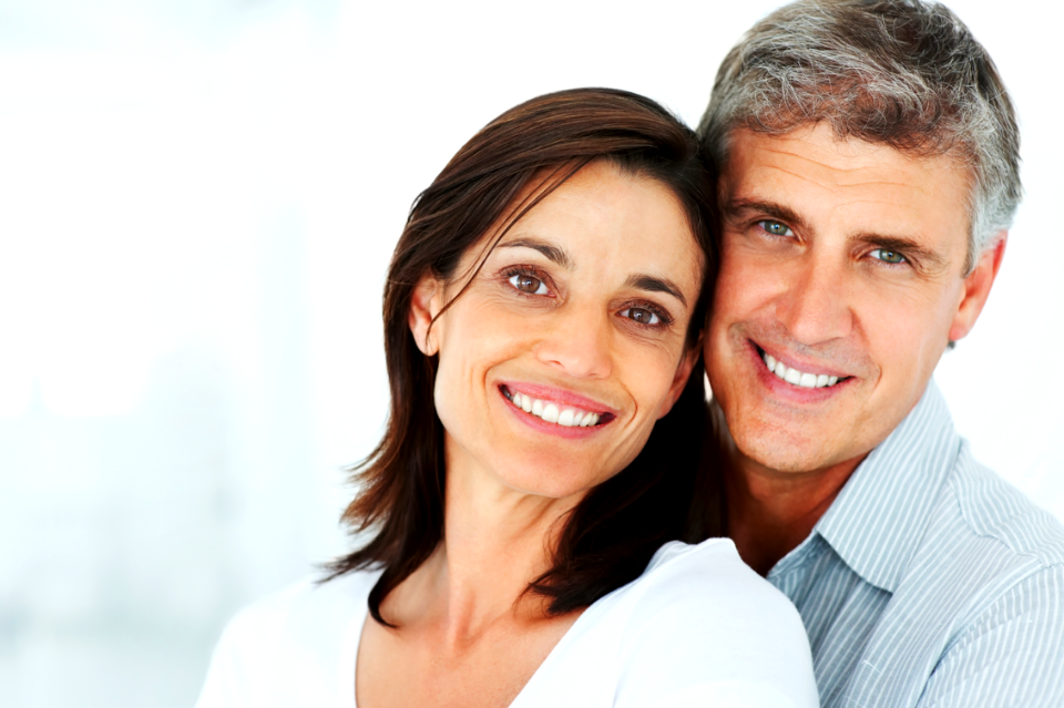 Closeup of a happy mature couple together over a background