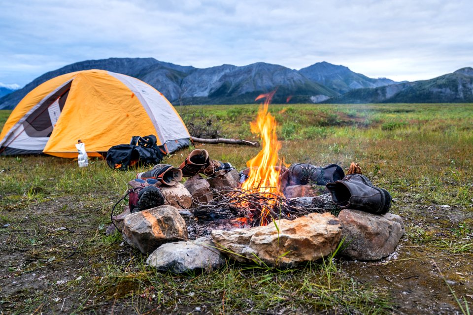 Drying out boots at a campfire
