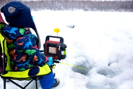 A small boy and family ice fishing. photo