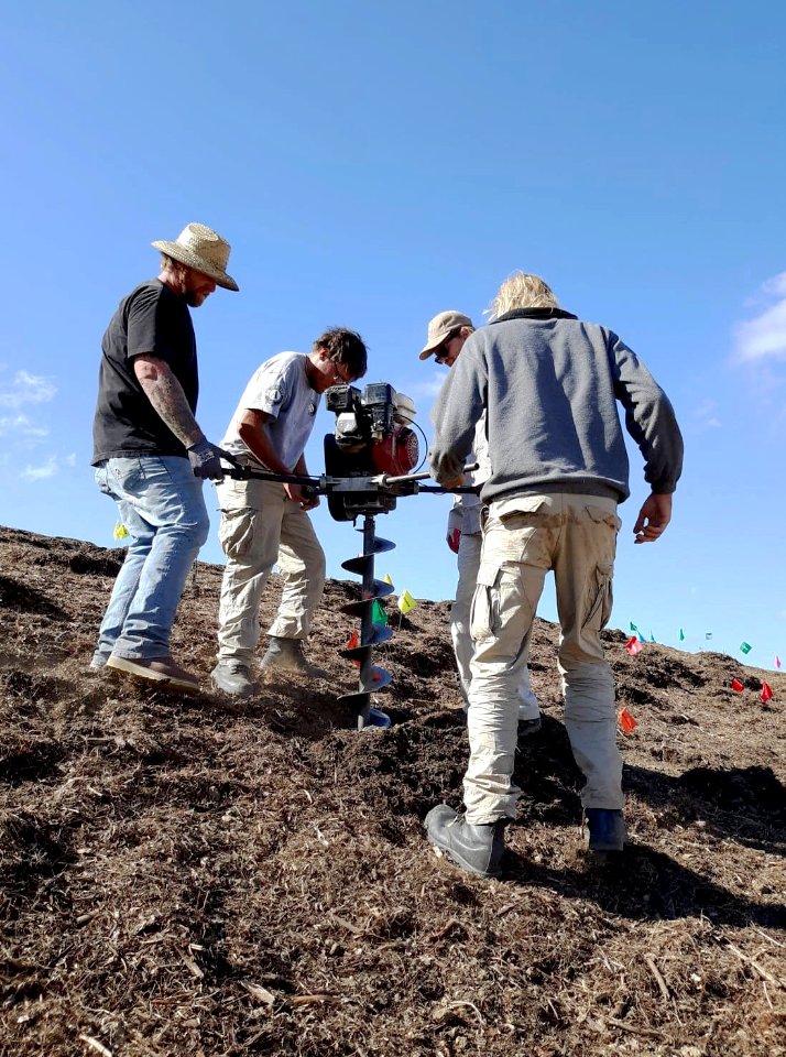 Volunteers create soil pits to place native plants in