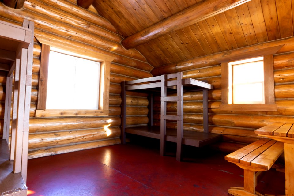 Interior of a log public use cabin.