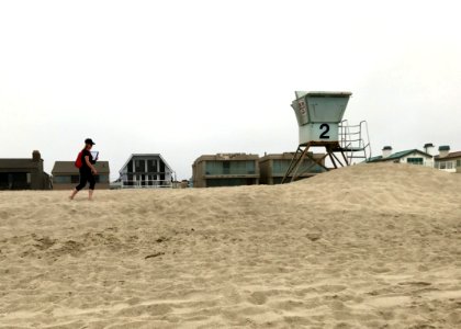 Andrea Dransfield, a BeachCOMBERS volunteer, surveys Silver Strand beach. photo