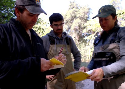 Eric Morrissette (l), a senior fish and wildlife biologist with the USFWS, takes notes on water quality from Jennifer Pareti, an environmental scientist with the CDFW, as Abram Tucker, a scientific aid with the CDFW watches. photo