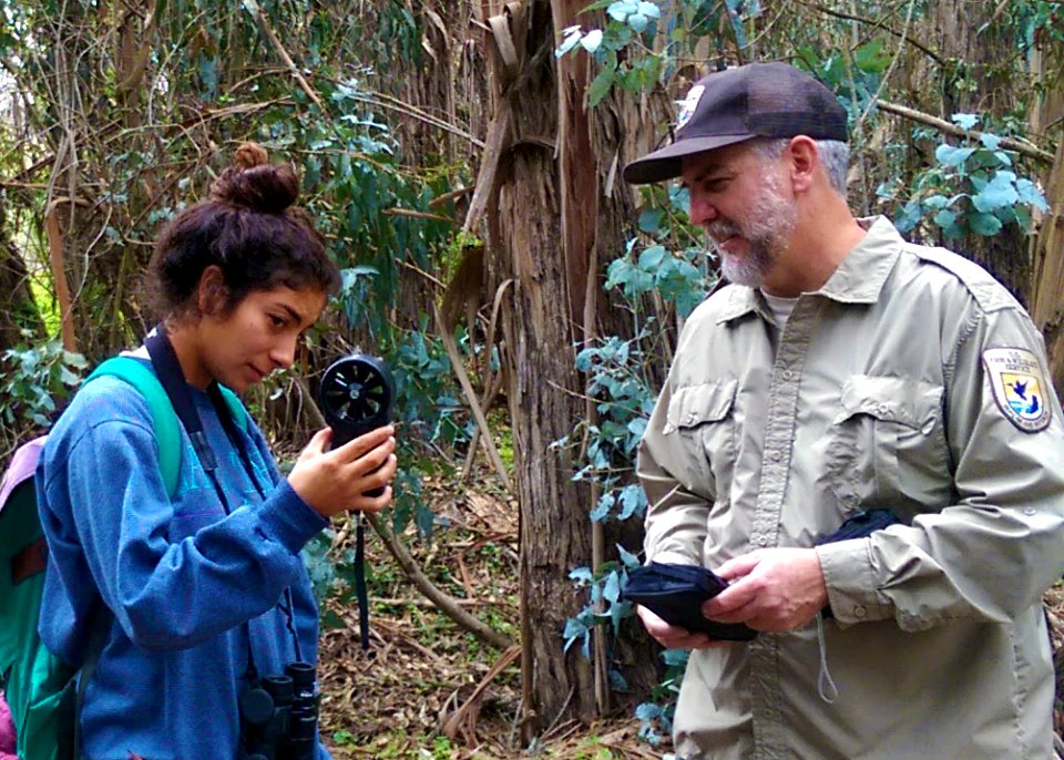 High school student Lauren Magdaleno providing Service biologist Michael Glenn weather measurements with the Kestrel weather meter.