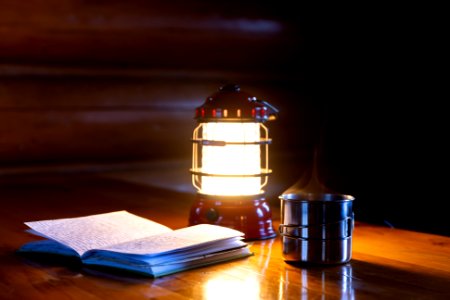 Reading the public use cabin log by lantern light. photo