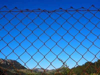 Diagonal wire mesh fence rusty rusted photo