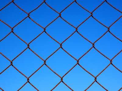 Diagonal wire mesh fence rusty rusted