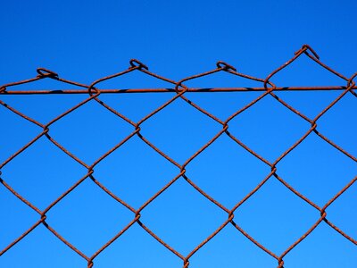 Diagonal wire mesh fence rusty rusted