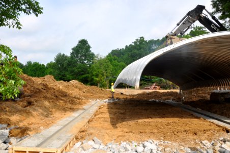 Happy Trail Culvert Project - carrying the culvert into place photo