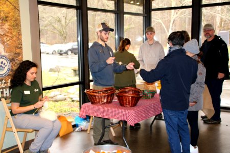 Park staff teach visitors to make buzz buttons at the 2018 Festival of Christmas Past, December 8, 2018--Warren Bielenberg