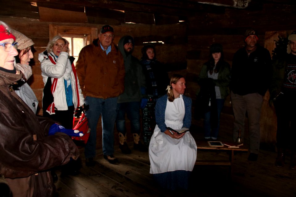 Ranger Jennifer Hale with visitors on the Christmas Memories Walk, 2018 Festival of Christmas Past, December 8, 2018--Warren Bielenberg