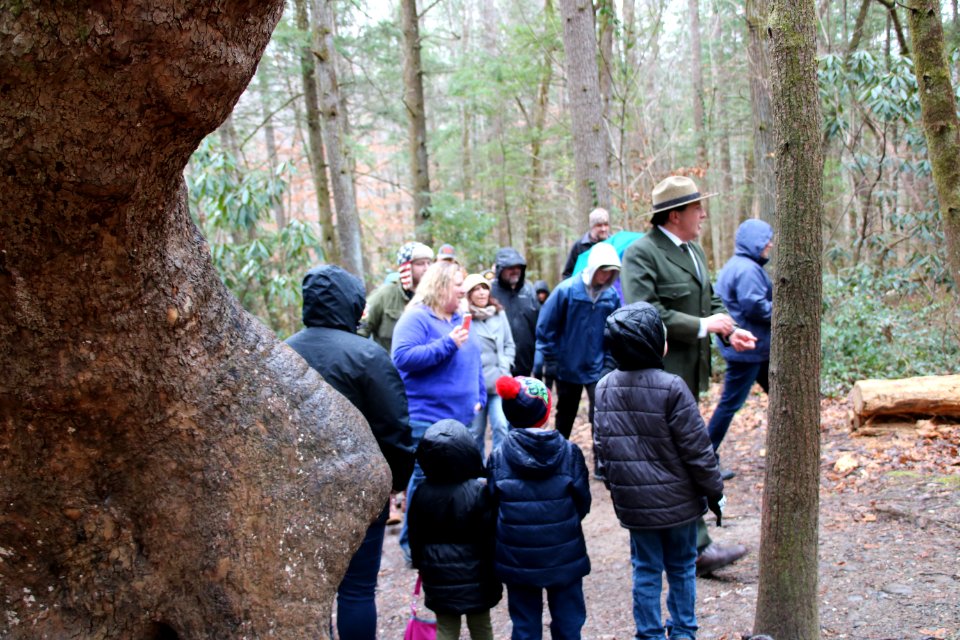 Volunteer Grant Palmer (as first superintendent Ross Eakin) with visitors on the Christmas Memories Walk at the 2018 Festival of Christmas Past, December 8, 2018--Warren Bielenberg
