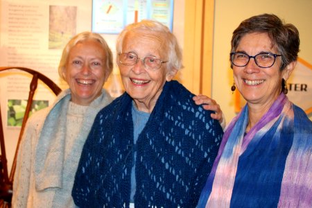 Volunteers pose next to spinning wheel, December 2017--Warren Bielenberg