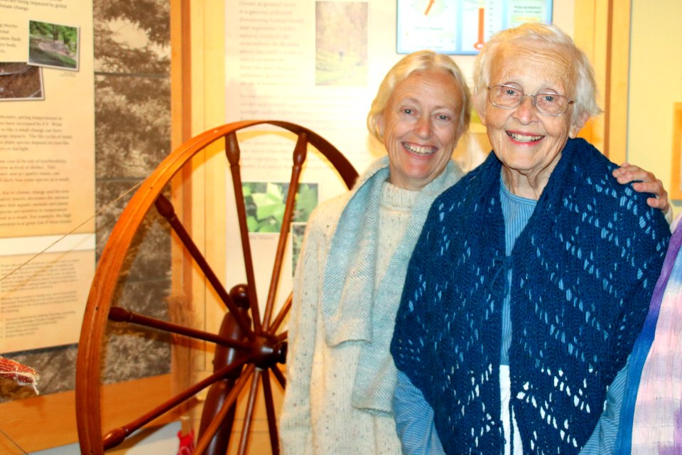 Volunteers pose with spinning wheel, December 2017--Warren Bielenberg