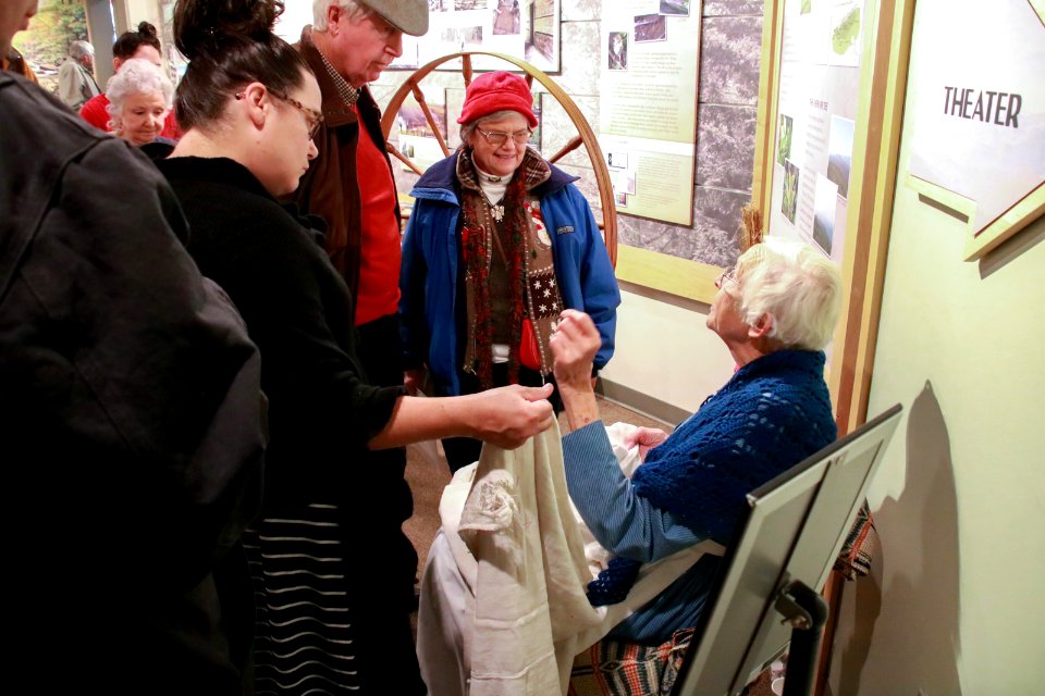Spinning wheel demonstrator talks with visitors, December 2017--Warren Bielenberg