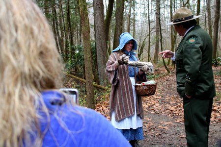 Volunteer Grant Palmer (as first superintendent Ross Eakin) with Ranger Jennifer Hale on the Christmas Memories Walk at the 2018 Festival of Christmas Past, December 8, 2018--Warren Bielenberg